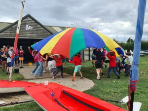Juniors playing with a parachute