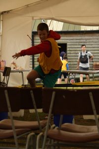 Yellow team leaping an obstacle