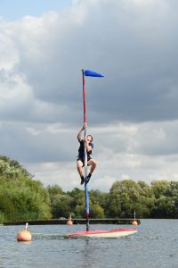 A junior halfway up a mast