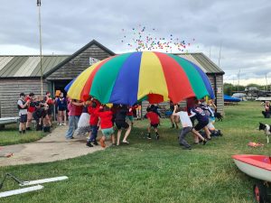 Juniors playing with a parachute